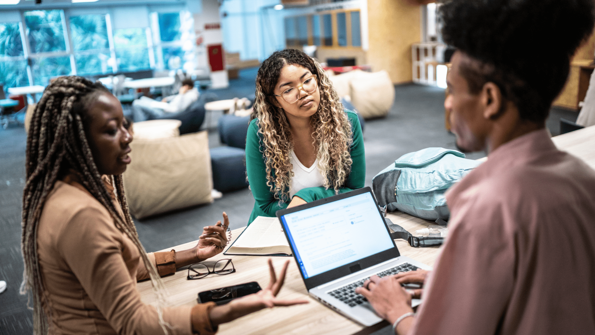students around a computer discussing scholarship applications